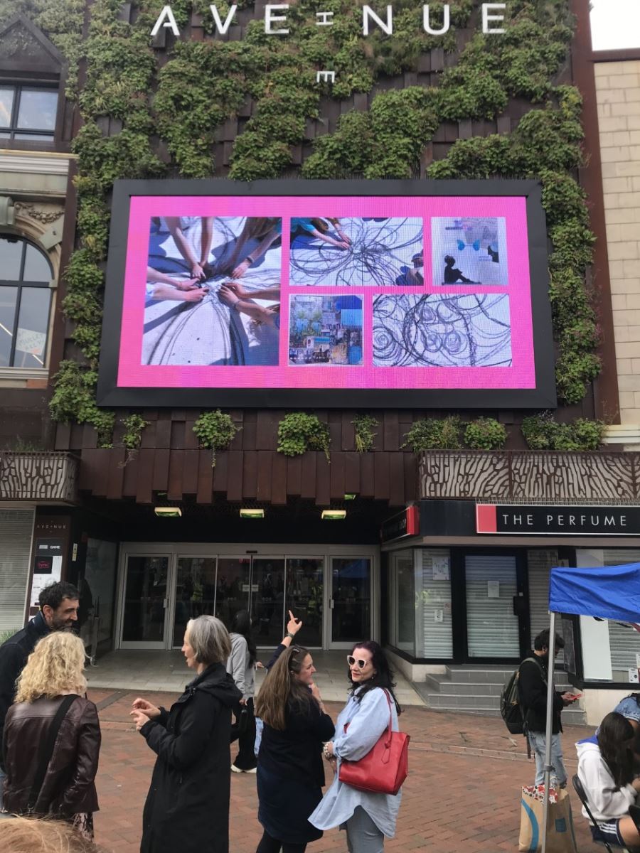 Art work displayed on a big screen outside the Avenue shopping centre in Bournemouth