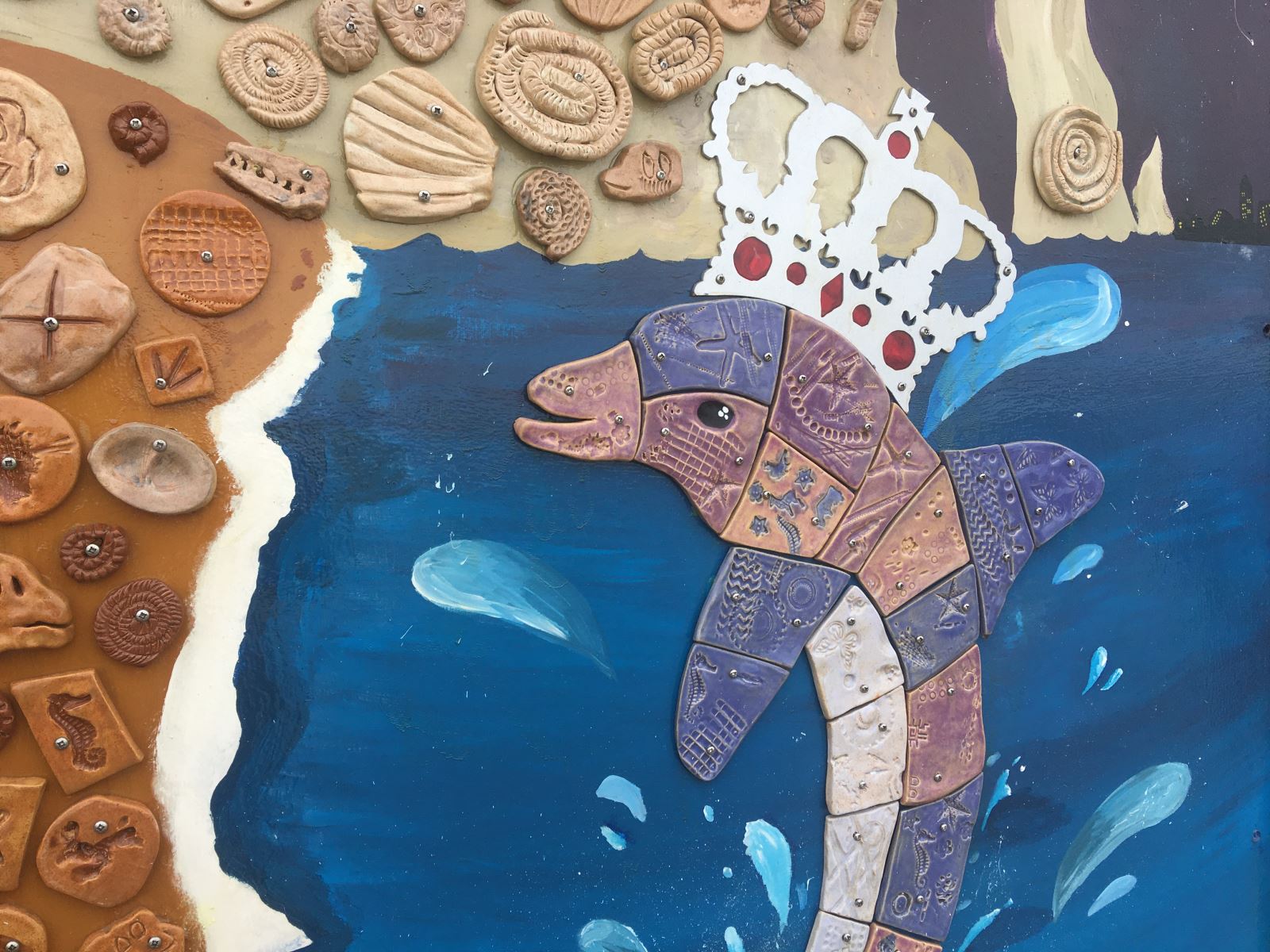 Swanage Jubilee Mural closeup of fossils and dolphin made from ceramic tiles